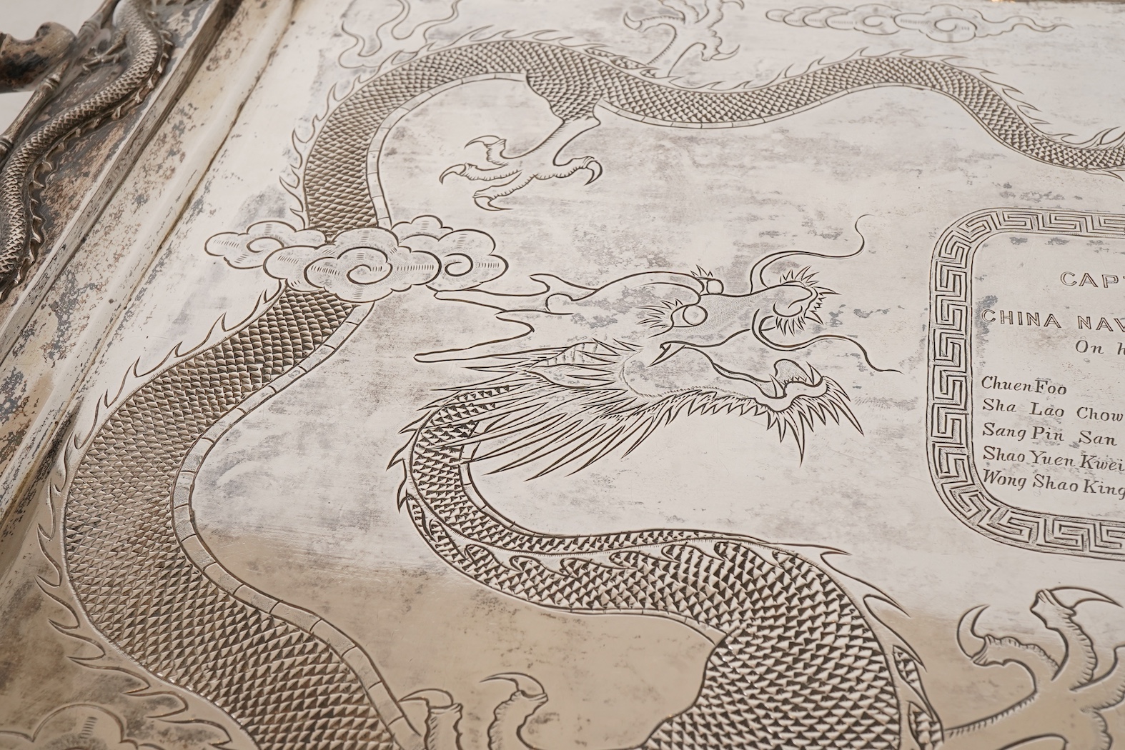 An early 20th century Chinese Export white metal two handled rectangular tea tray, by Luen Wo, Shanghai, with engraved presentation inscription, 'Presented to Captain John Whittle by the undersigned China Navigation Cos.